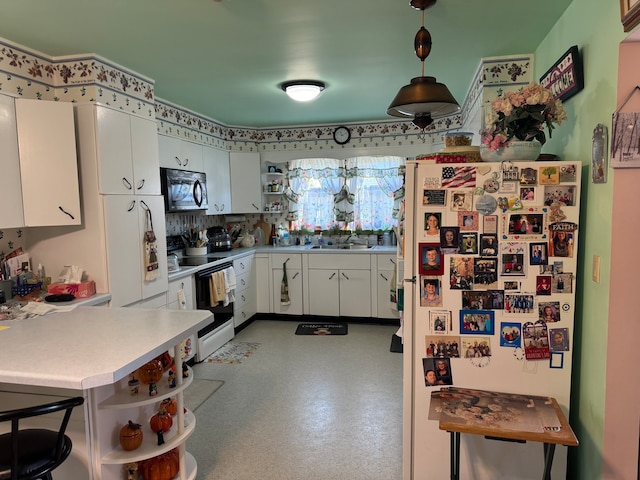 kitchen with kitchen peninsula, a kitchen bar, decorative light fixtures, white cabinetry, and white appliances