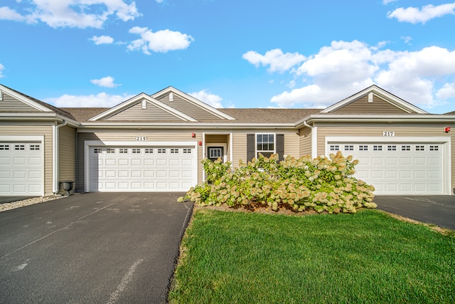 single story home with a front lawn and a garage