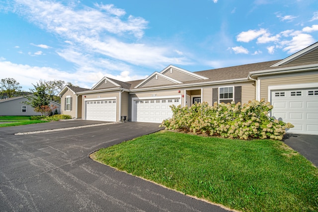 ranch-style house with a garage and a front lawn