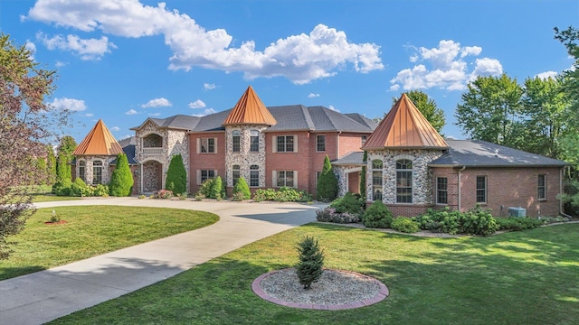 4703 W Kirby Ave, Champaign, IL 61822 - view of front of home with curved driveway, a front lawn, brick siding, and stone siding