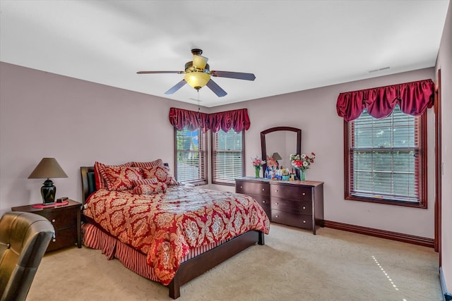 bedroom with light colored carpet and ceiling fan