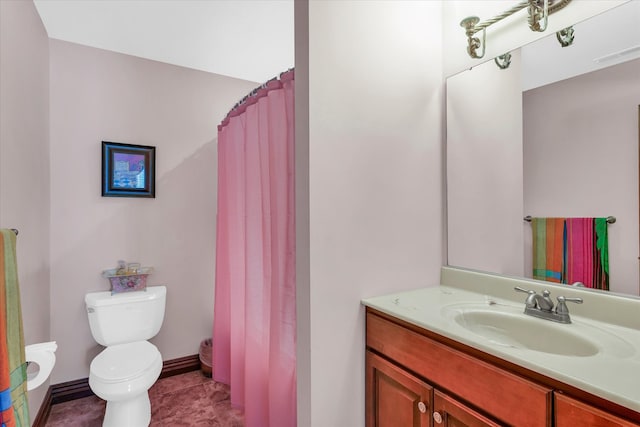 bathroom with vanity, toilet, and tile patterned floors