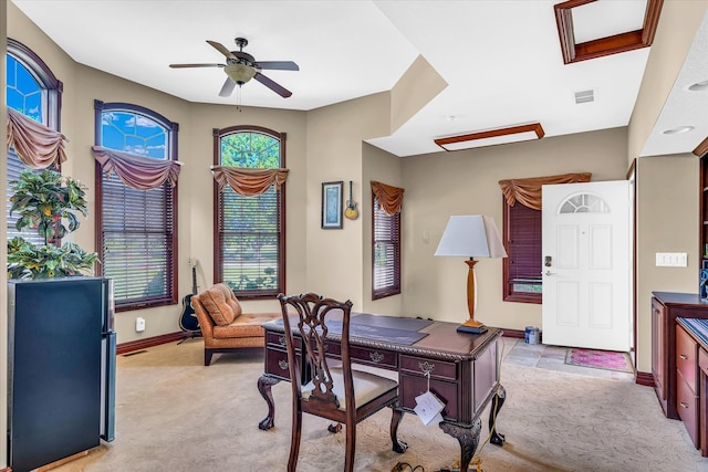 carpeted home office with ceiling fan