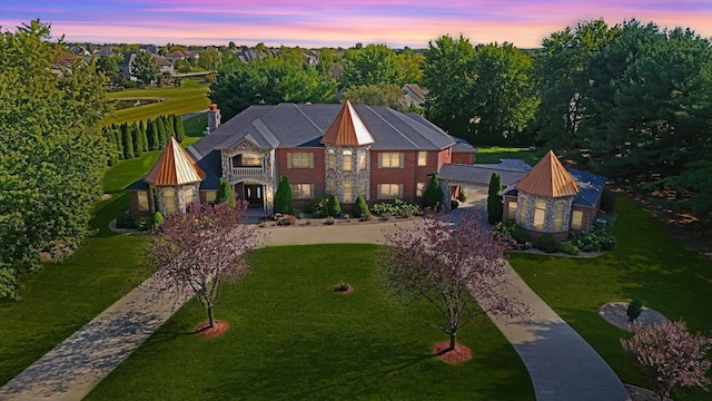 4703 W Kirby Ave, Champaign, IL 61822 - view of front of home with curved driveway, a standing seam roof, a front yard, and a metal roof
