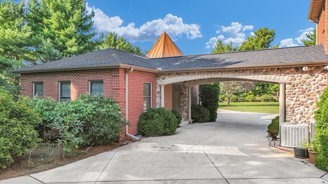 4703 W Kirby Ave, Champaign, IL 61822 - view of side of home with concrete driveway, brick siding, and roof with shingles