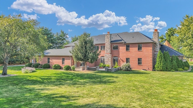 4703 W Kirby Ave, Champaign, IL 61822 - rear view of property with a chimney, a lawn, and brick siding