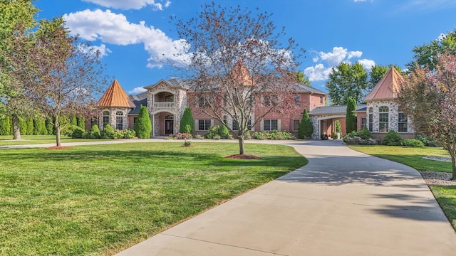 4703 W Kirby Ave, Champaign, IL 61822 - view of front of property with a front lawn, stone siding, and curved driveway