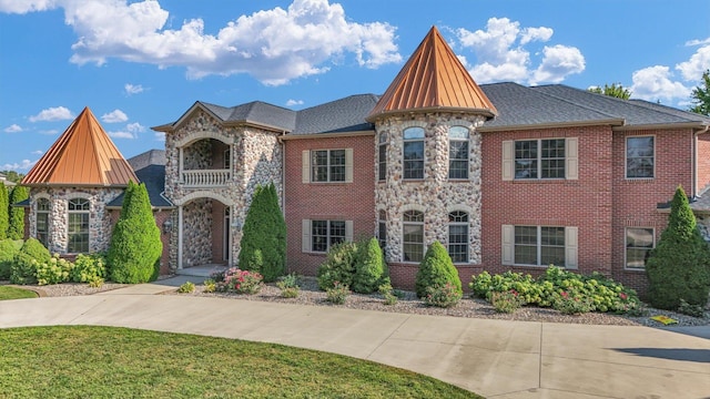 4703 W Kirby Ave, Champaign, IL 61822 - view of front of home with stone siding, a standing seam roof, and a front yard