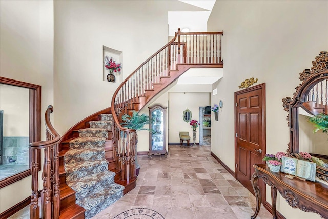 4703 W Kirby Ave, Champaign, IL 61822 - entryway featuring a high ceiling, stairs, and stone finish floors