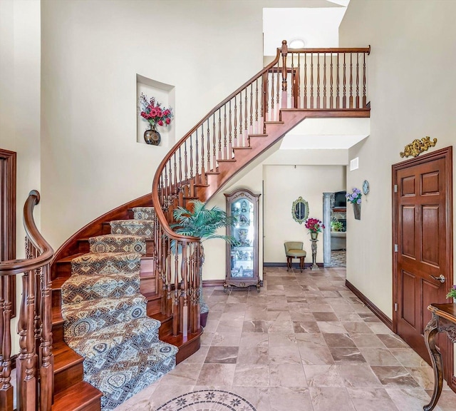 4703 W Kirby Ave, Champaign, IL 61822 - foyer featuring stairs, a towering ceiling, and stone finish flooring