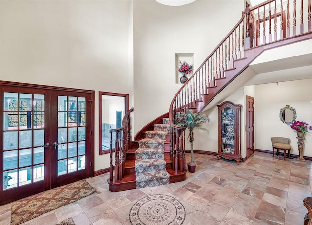 4703 W Kirby Ave, Champaign, IL 61822 - foyer with a high ceiling, french doors, stairs, and stone finish flooring