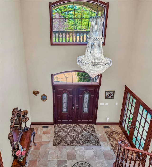 foyer entrance featuring french doors and an inviting chandelier