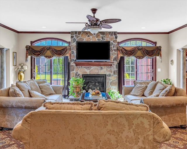 living room with ceiling fan, ornamental molding, and a fireplace