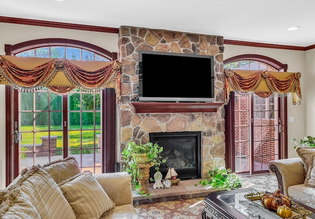 living room with ornamental molding and a fireplace