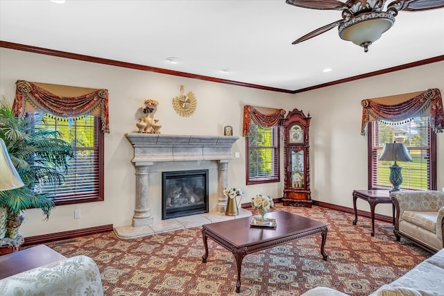 living room featuring crown molding, ceiling fan, and a fireplace