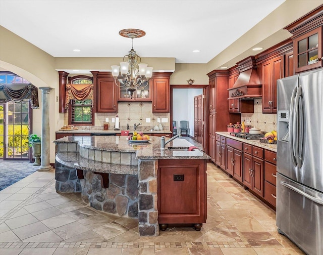 4703 W Kirby Ave, Champaign, IL 61822 - kitchen with stainless steel refrigerator with ice dispenser, custom range hood, a chandelier, pendant lighting, and a breakfast bar area