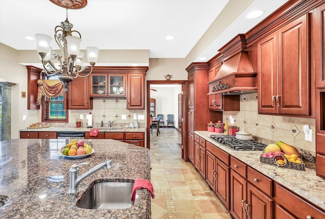 4703 W Kirby Ave, Champaign, IL 61822 - kitchen featuring a chandelier, appliances with stainless steel finishes, custom exhaust hood, decorative light fixtures, and decorative backsplash
