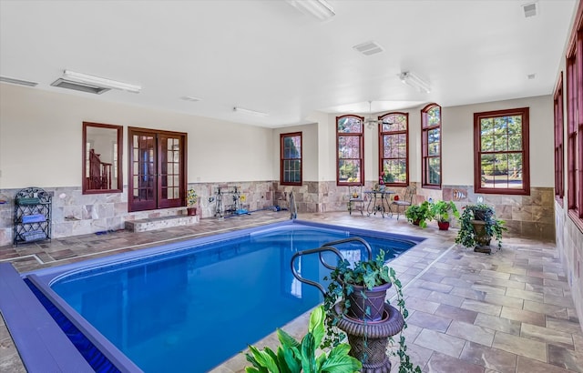 view of swimming pool featuring french doors