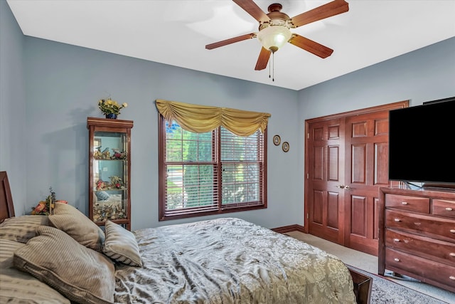 bedroom with carpet, ceiling fan, and a closet