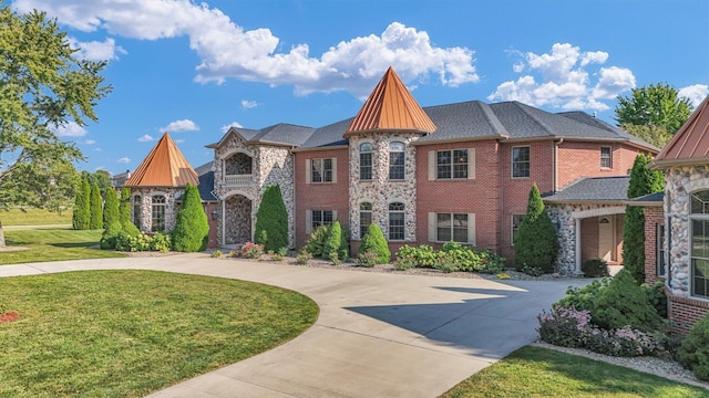 4703 W Kirby Ave, Champaign, IL 61822 - view of front facade with curved driveway, a front yard, and stone siding