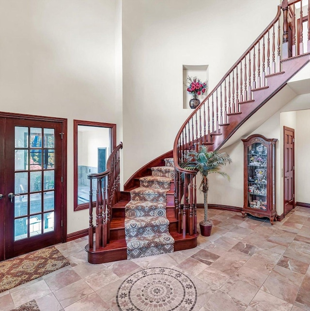 4703 W Kirby Ave, Champaign, IL 61822 - foyer entrance with a high ceiling, stairway, and stone finish floors