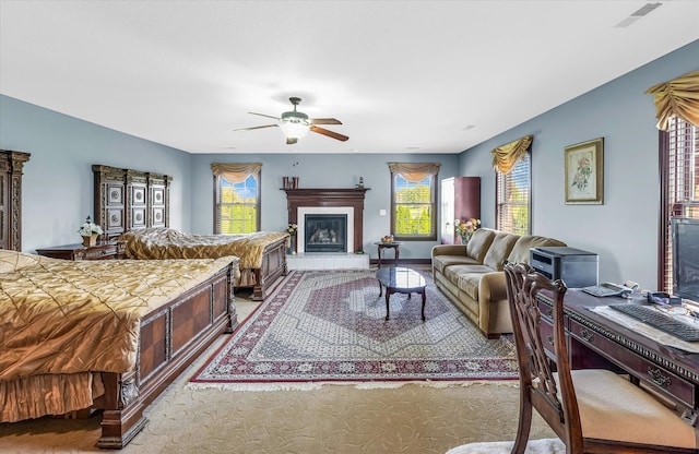 carpeted living room with ceiling fan