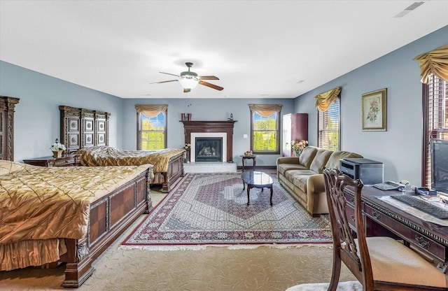 4703 W Kirby Ave, Champaign, IL 61822 - bedroom featuring a glass covered fireplace, carpet, and ceiling fan