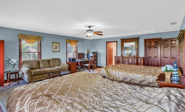 bedroom with ceiling fan and a closet