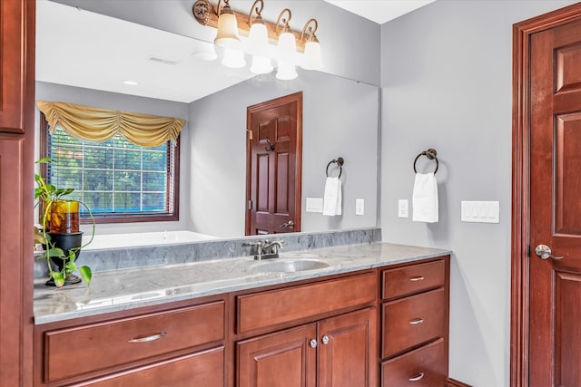 bathroom featuring a tub to relax in and vanity