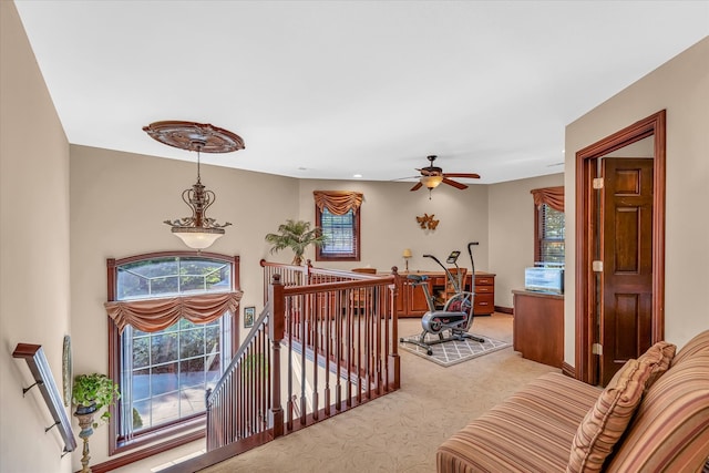 interior space with carpet flooring and ceiling fan