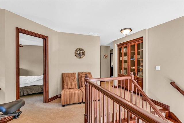 4703 W Kirby Ave, Champaign, IL 61822 - corridor with light colored carpet and an upstairs landing
