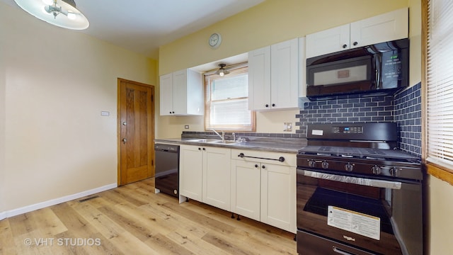 kitchen featuring light hardwood / wood-style flooring, white cabinetry, sink, black appliances, and decorative backsplash