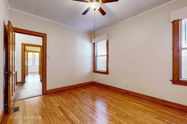 spare room featuring ornamental molding, ceiling fan, and light hardwood / wood-style floors