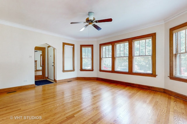 spare room with light hardwood / wood-style flooring, ceiling fan, and ornamental molding