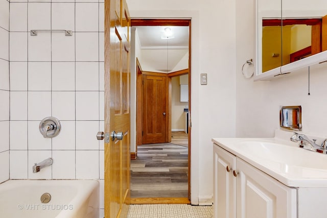 bathroom featuring vanity, hardwood / wood-style flooring, and shower / bathing tub combination