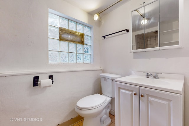 bathroom with tile patterned floors, toilet, and vanity