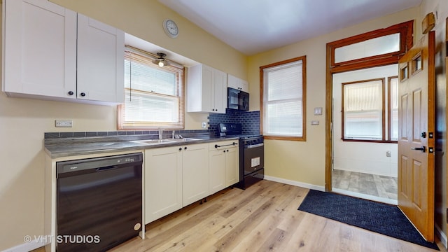 kitchen featuring black appliances, white cabinetry, and light hardwood / wood-style floors