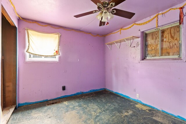 unfurnished room with a ceiling fan and visible vents