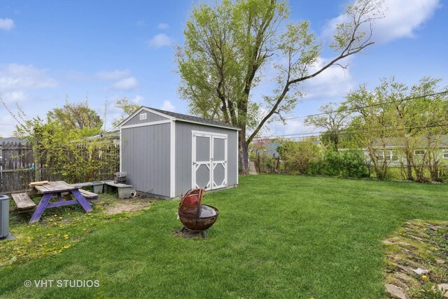 view of shed featuring central air condition unit and fence