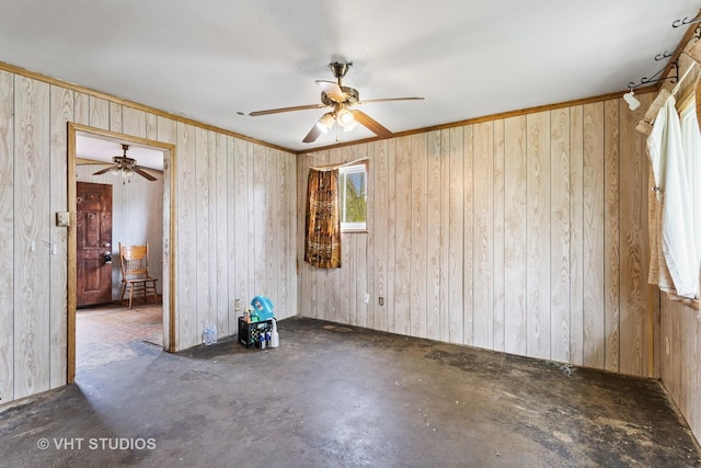 empty room with wooden walls, ceiling fan, and unfinished concrete floors