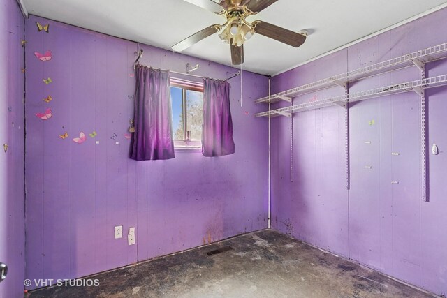 unfurnished bedroom featuring a ceiling fan, concrete floors, and visible vents