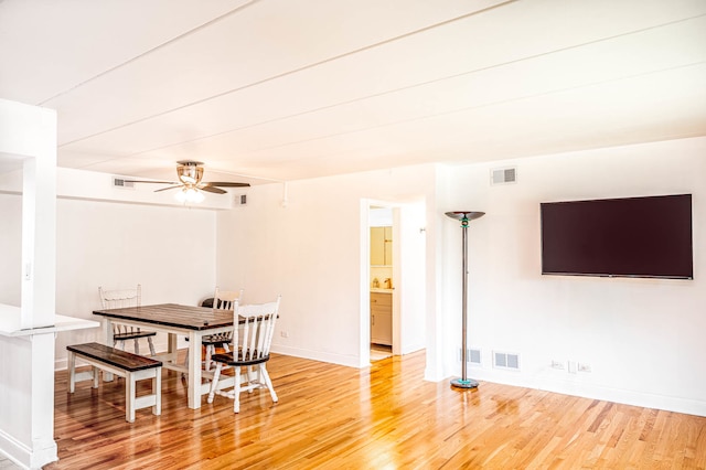 dining room with hardwood / wood-style flooring and ceiling fan