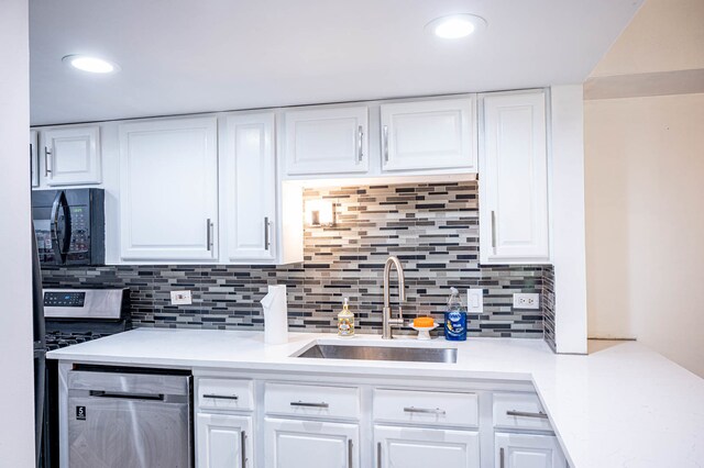 kitchen featuring white cabinets, stainless steel appliances, tasteful backsplash, and sink