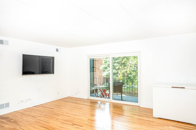 spare room featuring light hardwood / wood-style floors