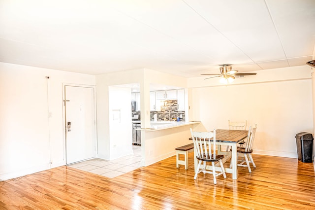 dining space featuring light wood-type flooring and ceiling fan