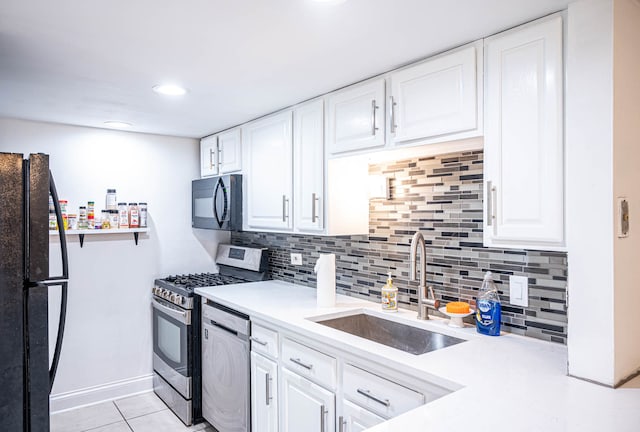 kitchen featuring black appliances, sink, light tile patterned floors, and white cabinetry