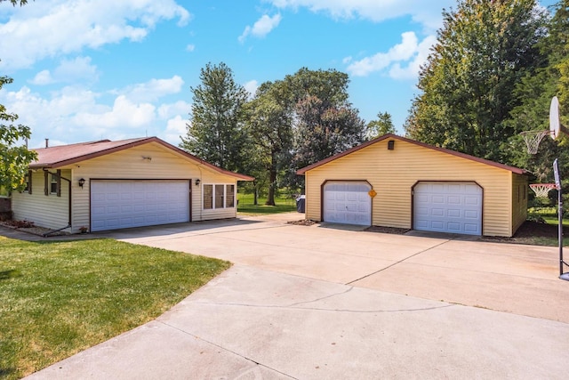 exterior space with a front yard, a garage, and an outdoor structure