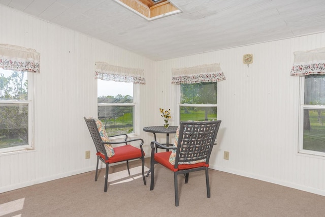 carpeted dining room with baseboards and a skylight