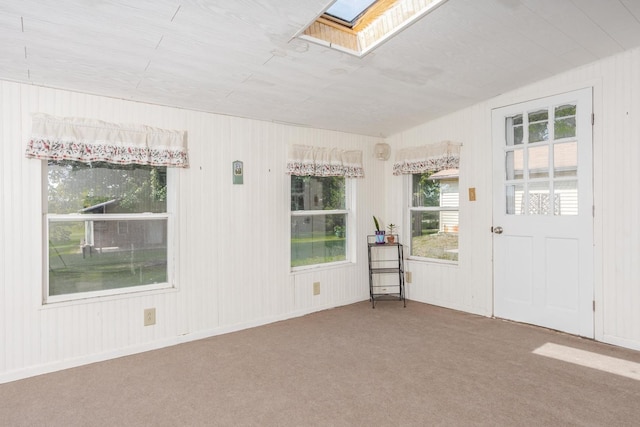 carpeted spare room with a skylight