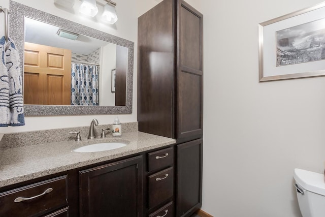 bathroom with vanity, toilet, and a shower with curtain